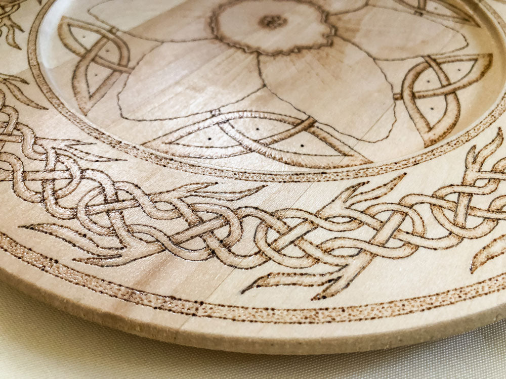 Celtic-inspired woodburned decorative plate featuring a daffodil mandala
