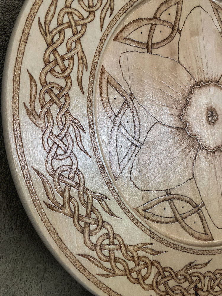 Celtic-inspired woodburned decorative plate featuring a daffodil mandala