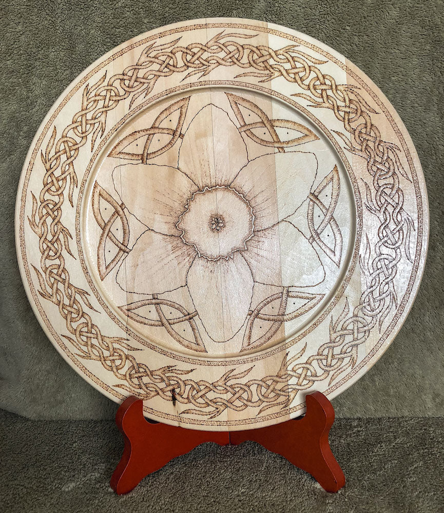 Decorative plate with Celtic flower and interlace knot design on a stand
