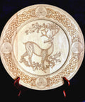 Decorative plate with a deer and Celtic knot design on a black background