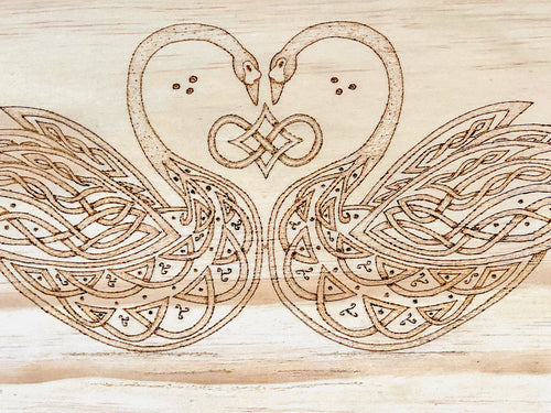 Celtic-inspired knotwork swans woodburned plaque