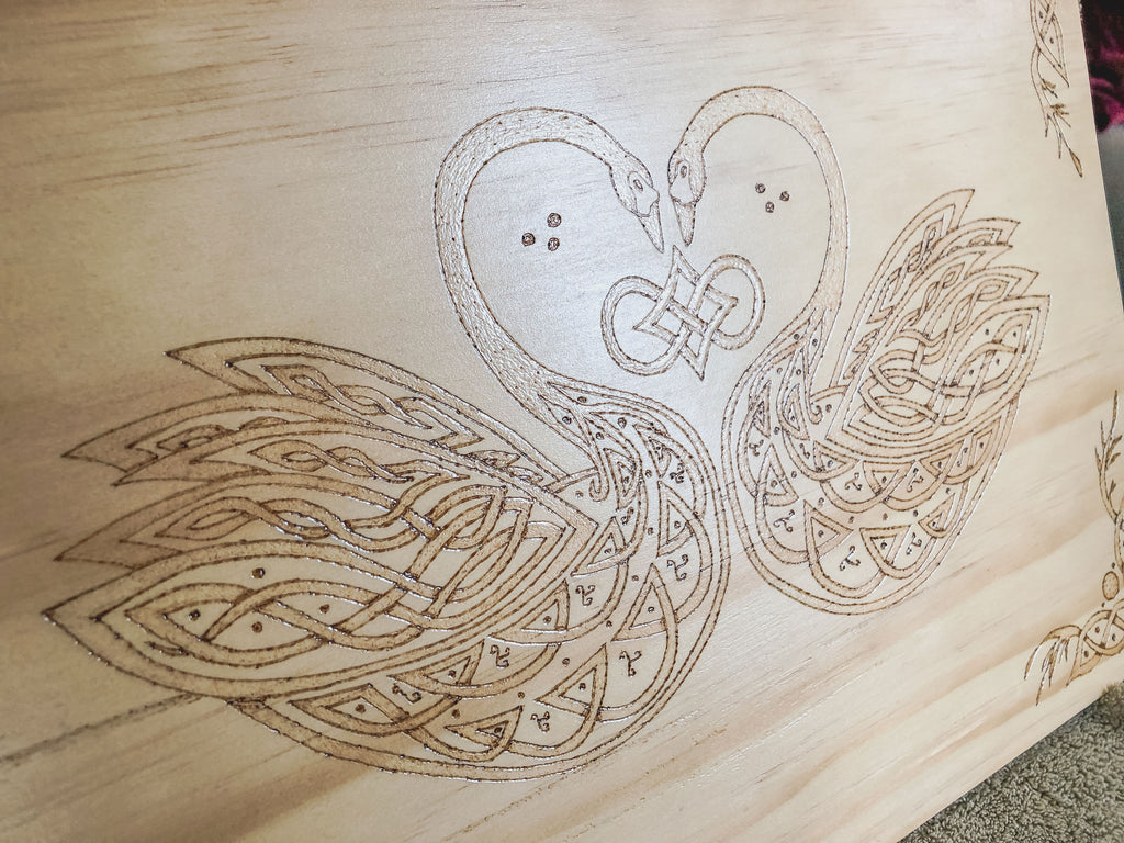 Celtic-inspired knotwork swans woodburned plaque
