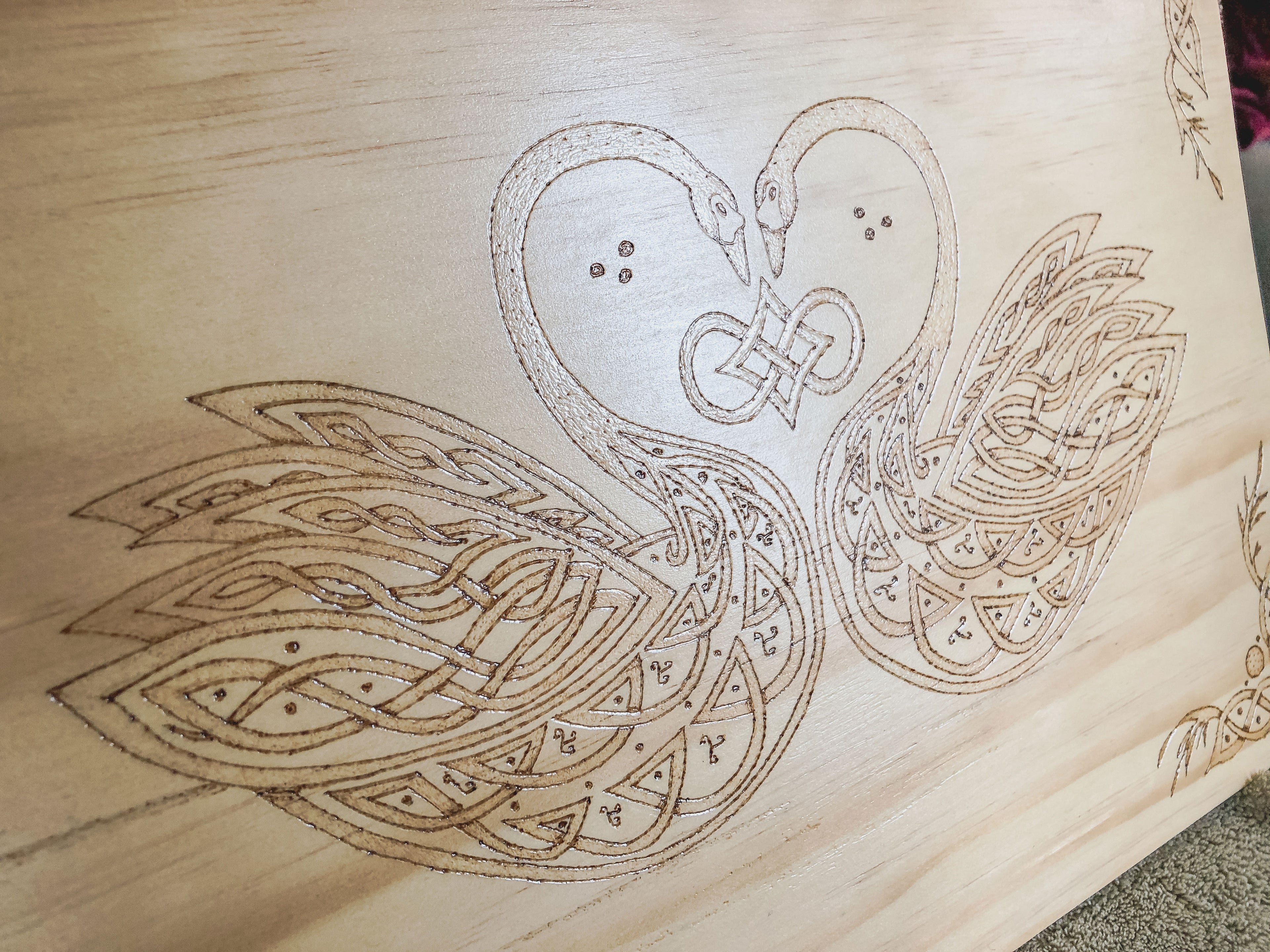 Celtic-inspired knotwork swans woodburned plaque