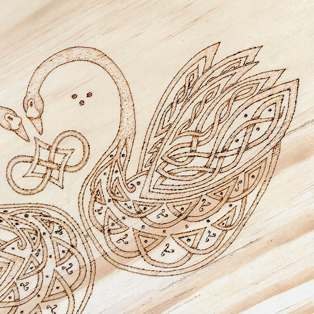 Celtic-inspired knotwork swans woodburned plaque