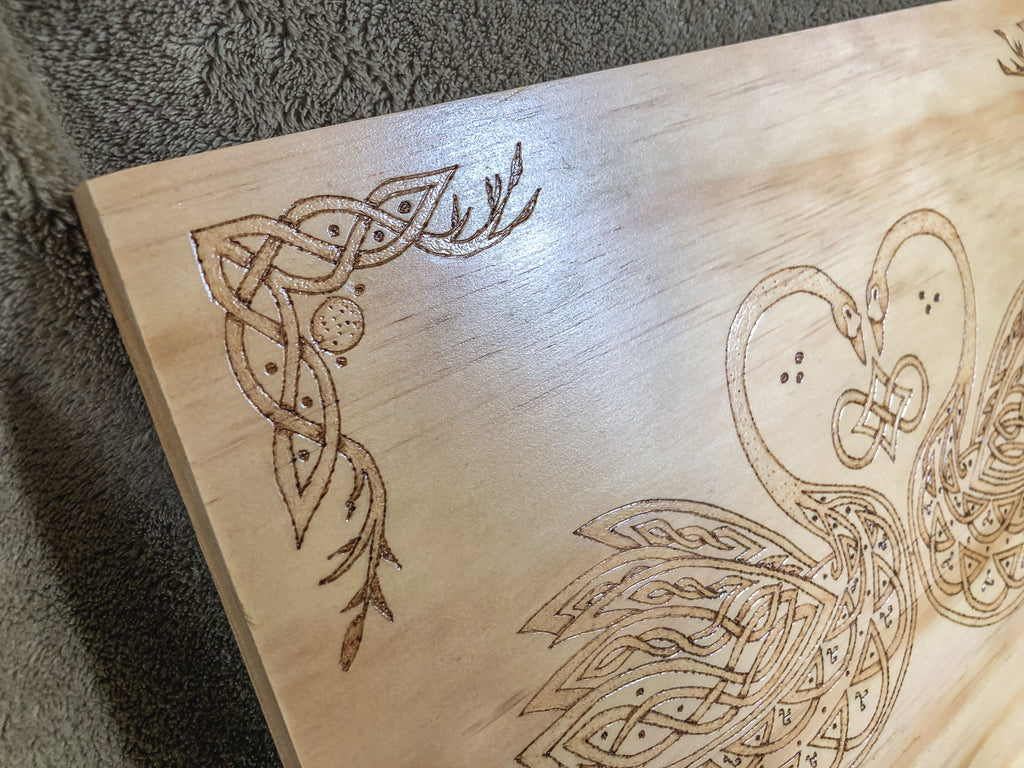 Celtic-inspired knotwork swans woodburned plaque