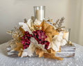 Festive three-tiered wooden candleholder with faux autumn flowers and leaves