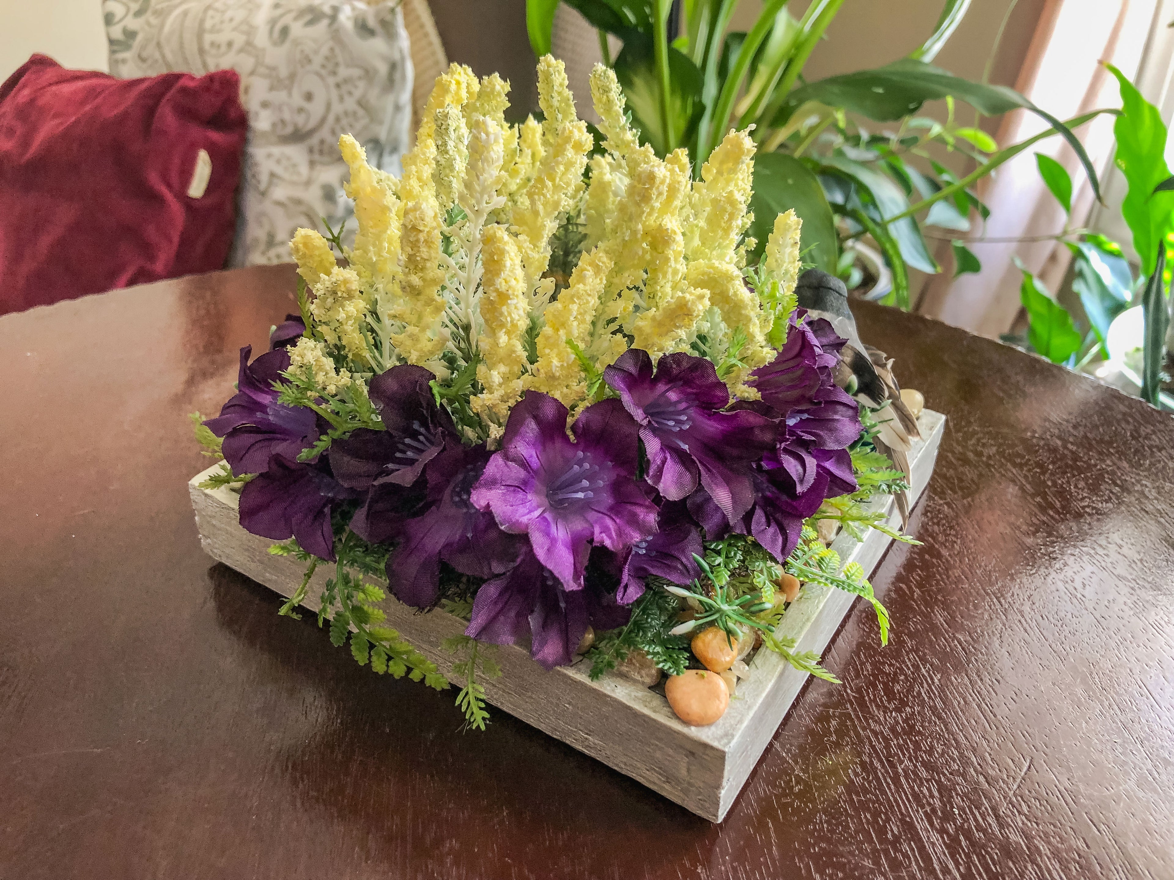 Candleholder with white and purple faux florals and a bird
