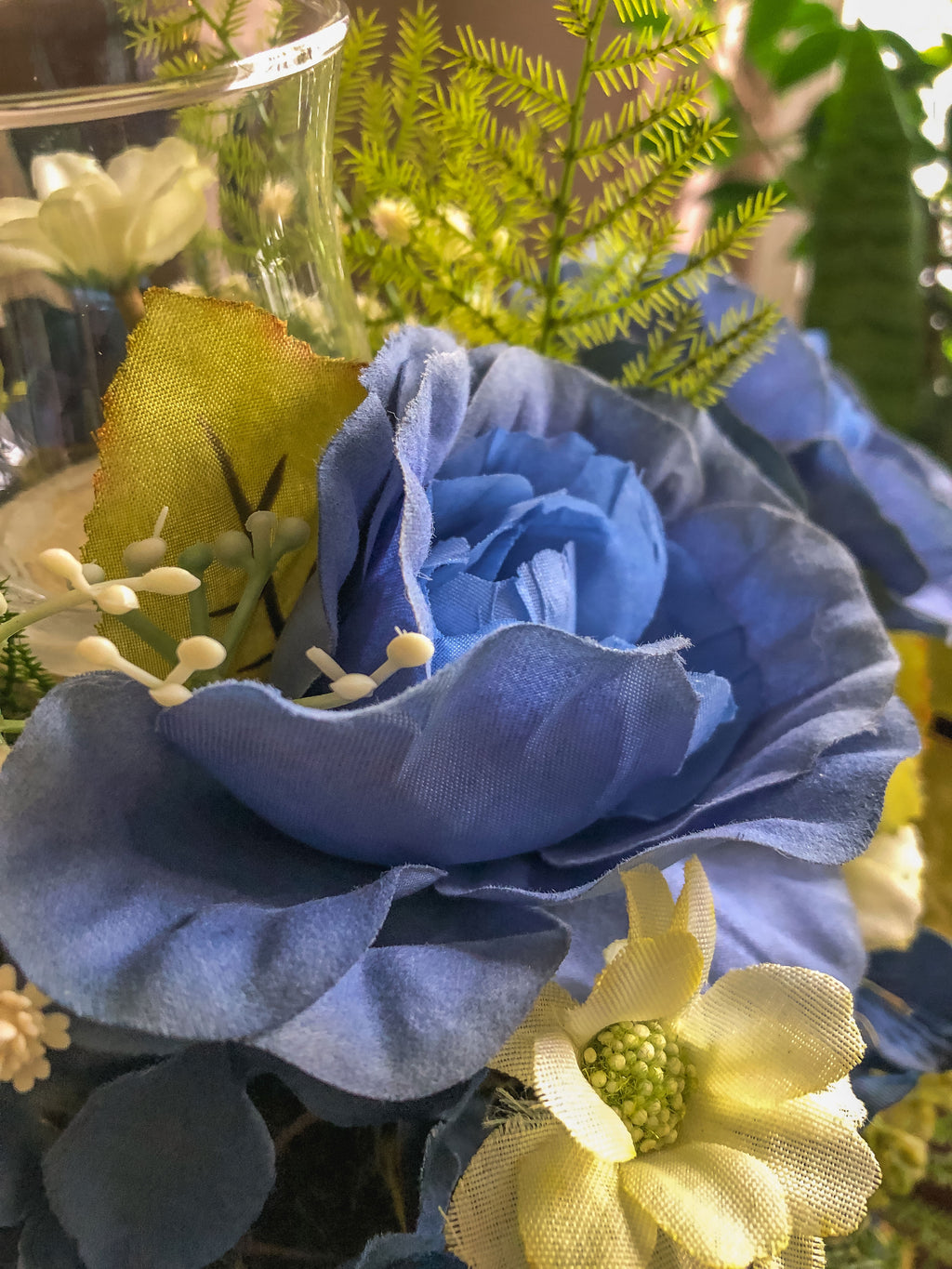 Wood candleholder with blue fabric rose and hydrangea arrangement