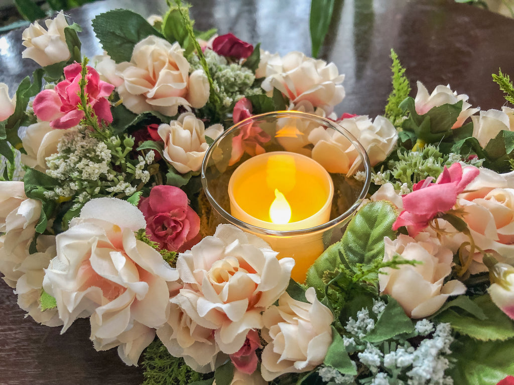 Votive candleholder with miniature coral roses in a tray