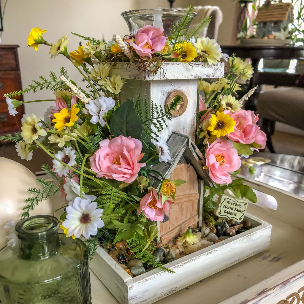 Fairy themed candleholder with miniature faux florals in a tray