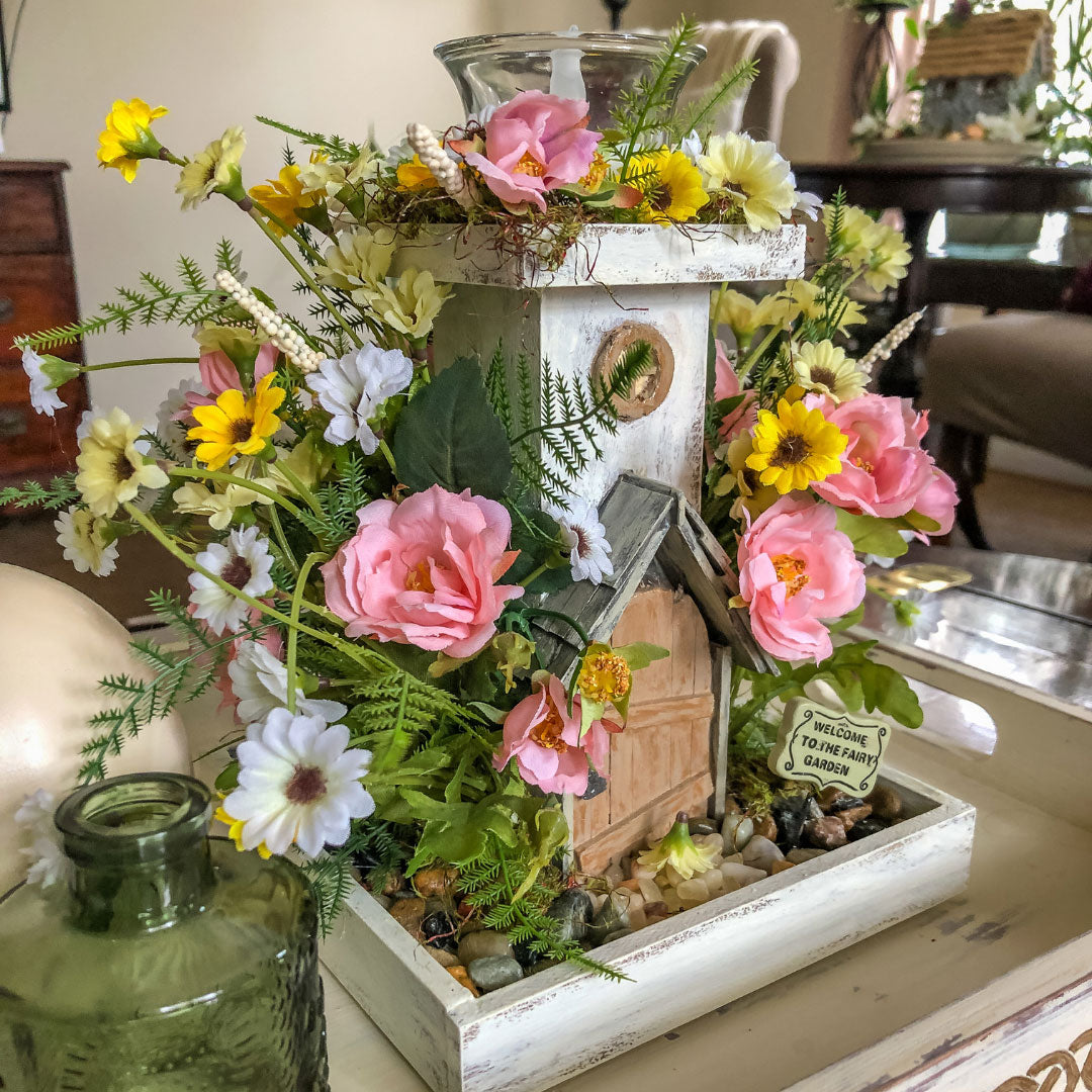 Fairy themed candleholder with miniature faux florals in a tray