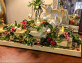 Garden themed candleholder with miniature faux roses on a table with a dragon