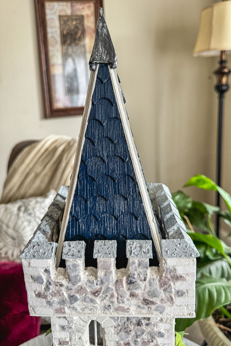Handcrafted wood and stone fairy castle with faux florals