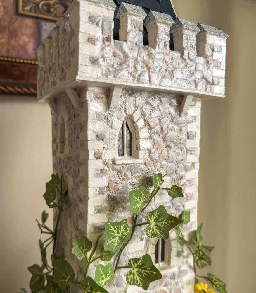 Handcrafted wood and stone fairy castle with faux florals