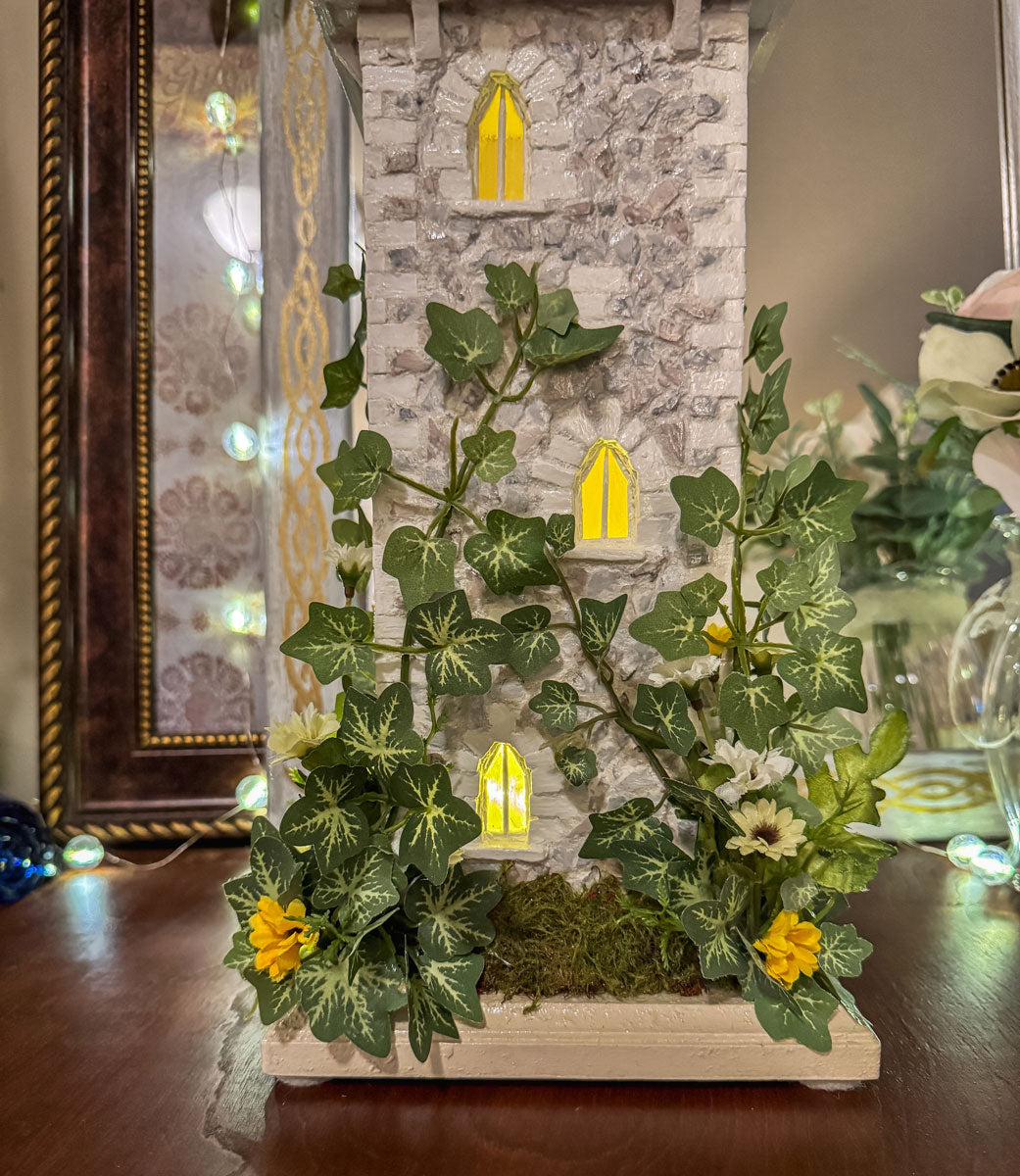 Handcrafted wood and stone fairy castle with faux florals