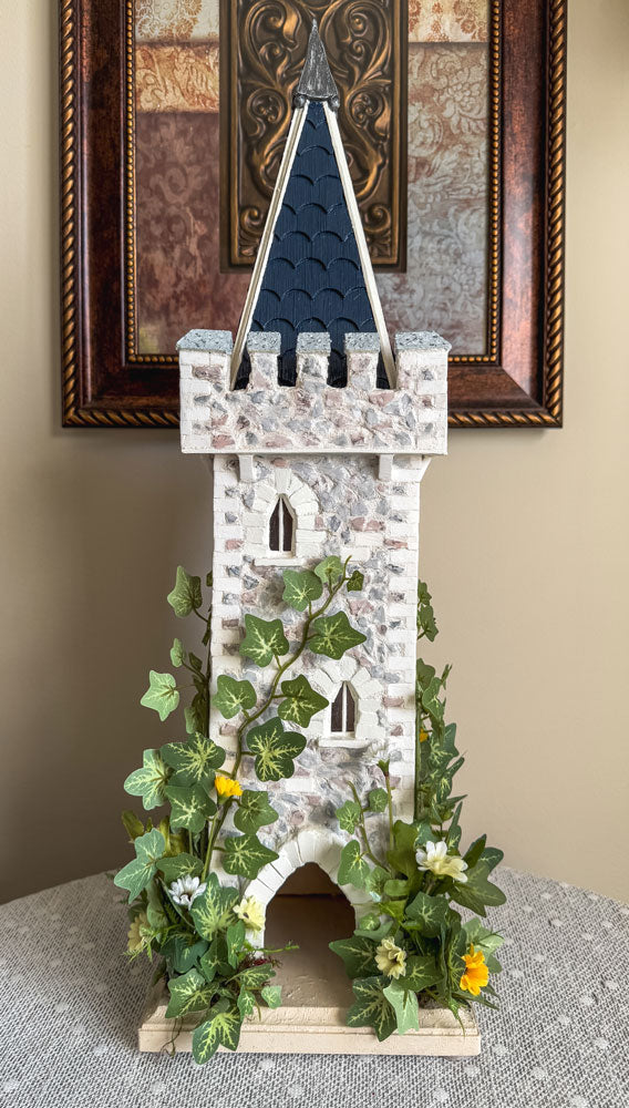 Handcrafted wood and stone fairy castle with faux florals