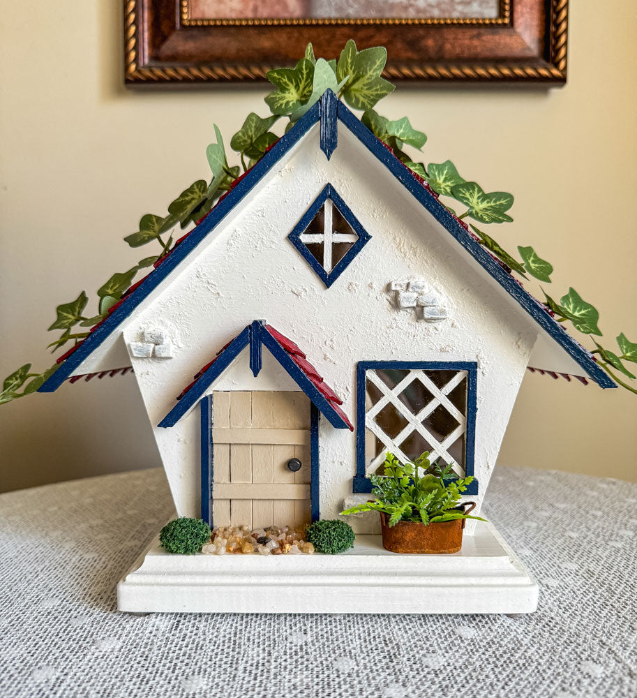 Red, white, and blue woodland fairy cottage with drop gable