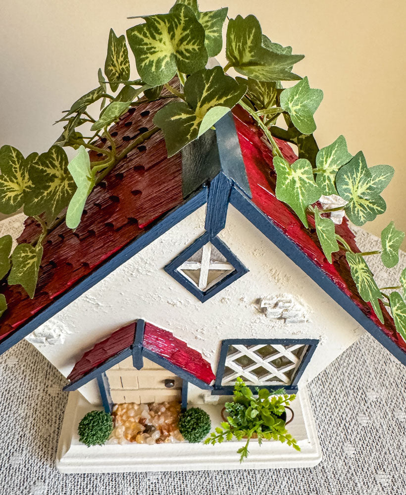 Red, white, and blue woodland fairy cottage with drop gable