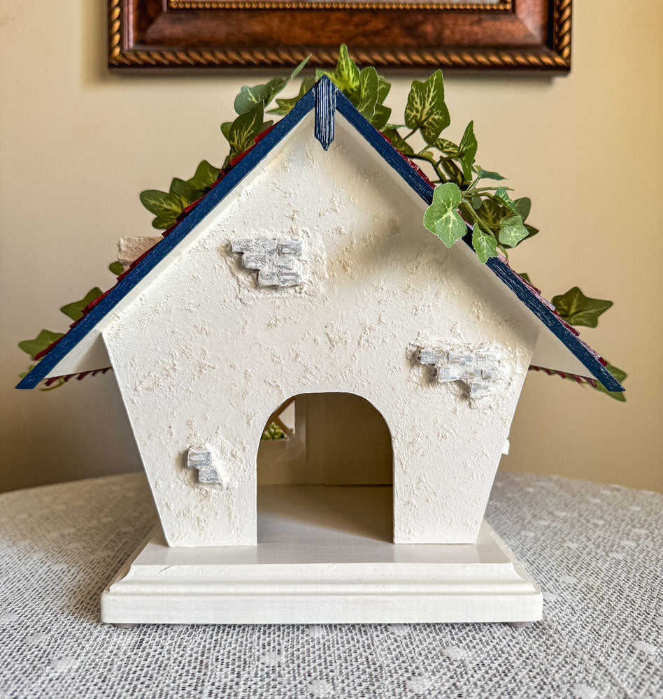 Red, white, and blue woodland fairy cottage with drop gable