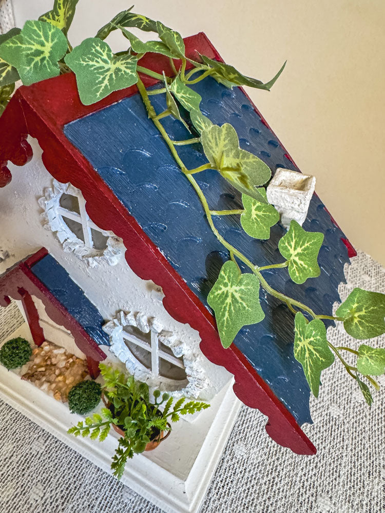 Red, white, and blue woodland fairy cottage with scalloped roof trim