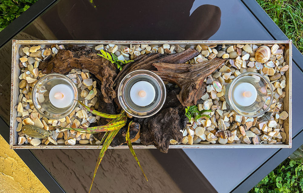 Votive candleholder with seashell-lined tray and driftwood