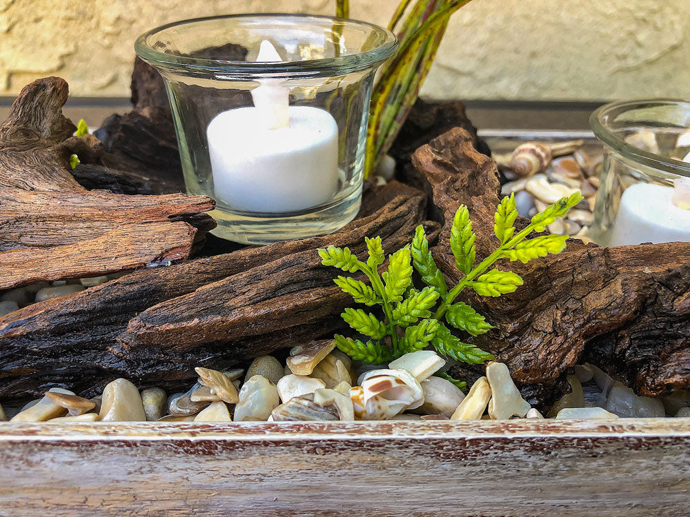 Votive candleholder with seashell-lined tray and driftwood