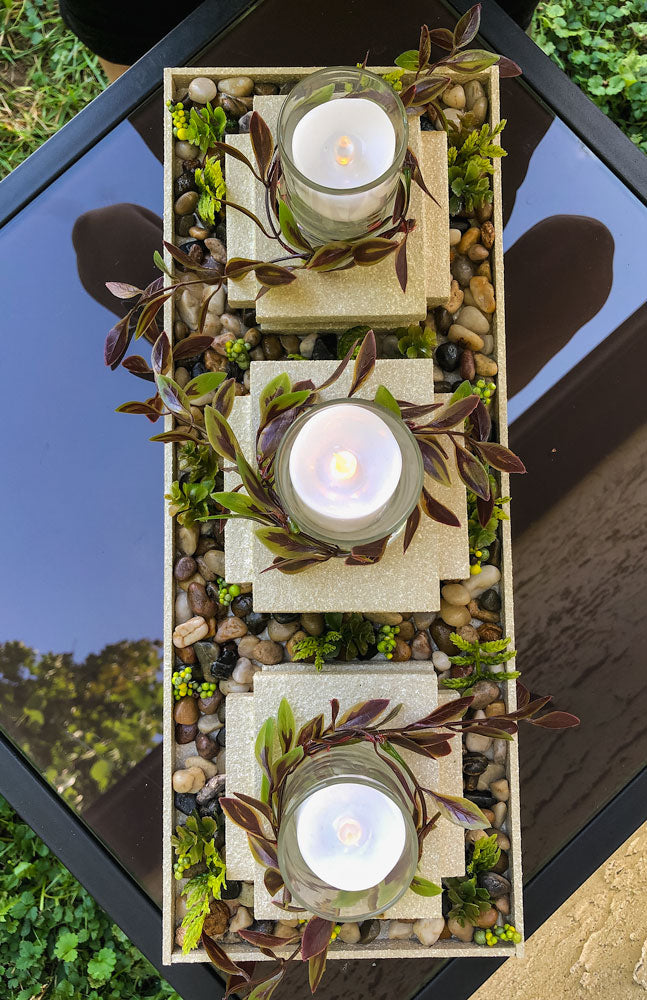 Garden-thermed votive candleholder with three stacked pillars
