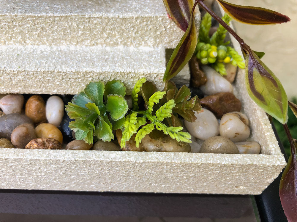 Garden-thermed votive candleholder with three stacked pillars