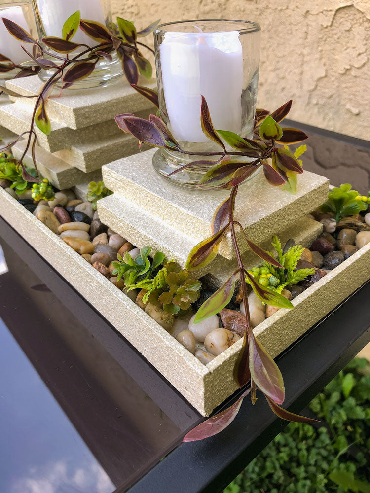 Garden-thermed votive candleholder with three stacked pillars
