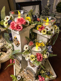 Three pillar fairy tower themed candle holder with faux florals and LED lights