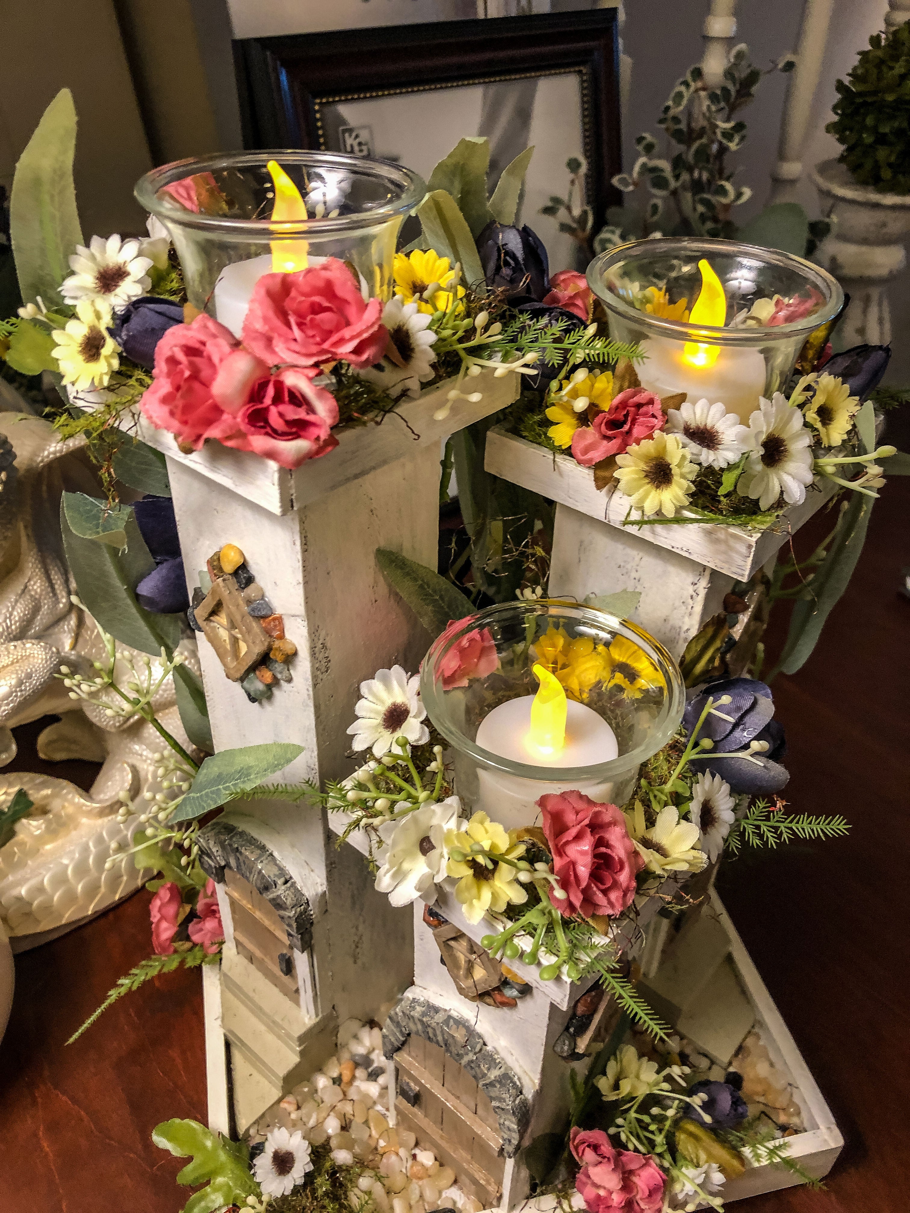 Three pillar fairy tower themed candle holder with faux florals and LED lights