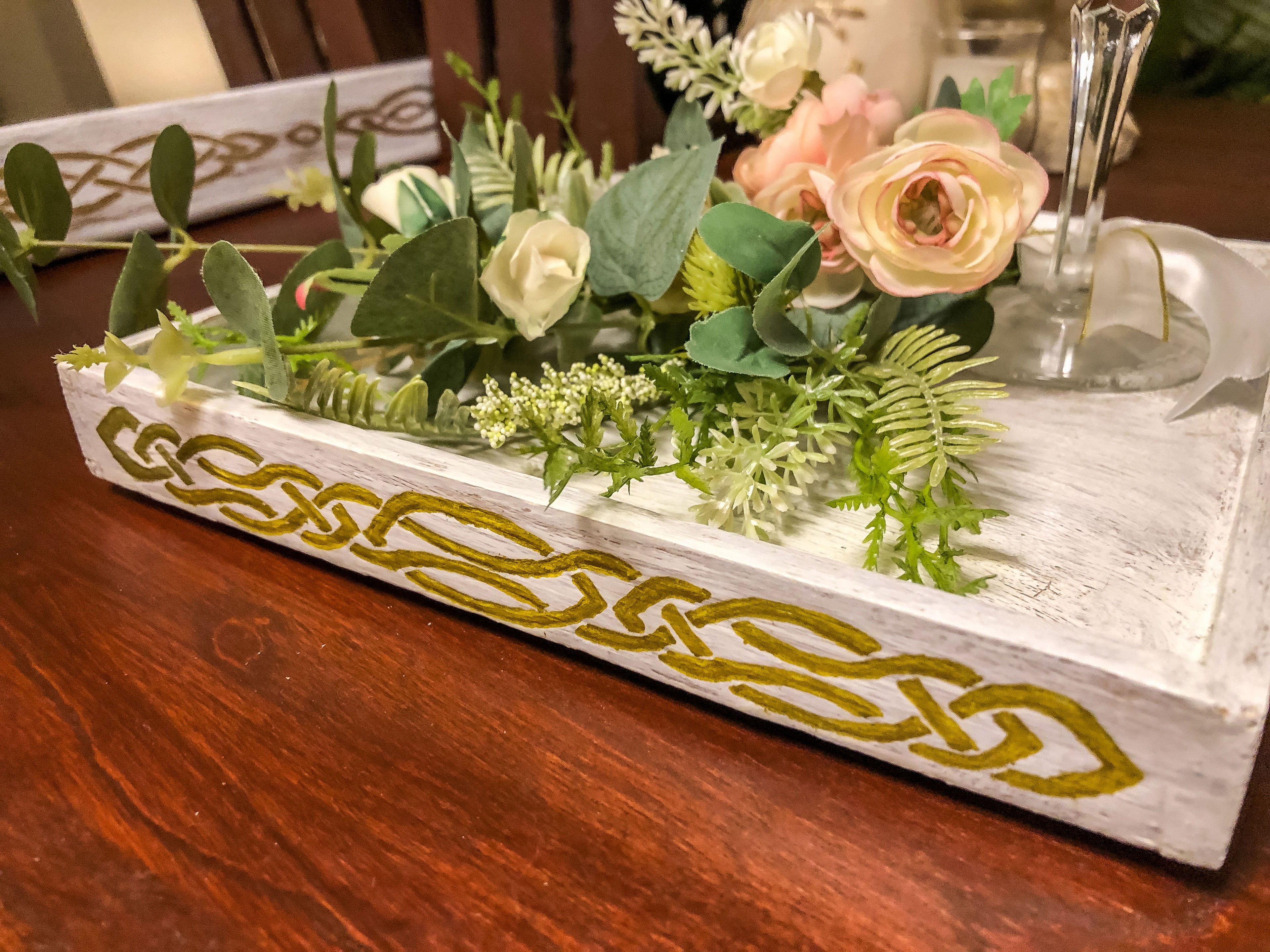 Wedding-inspired faux floral display with up-cycled champagne glass in a tray