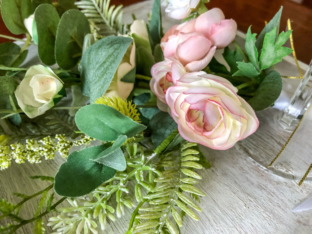 Wedding-inspired faux floral display with up-cycled champagne glass in a tray