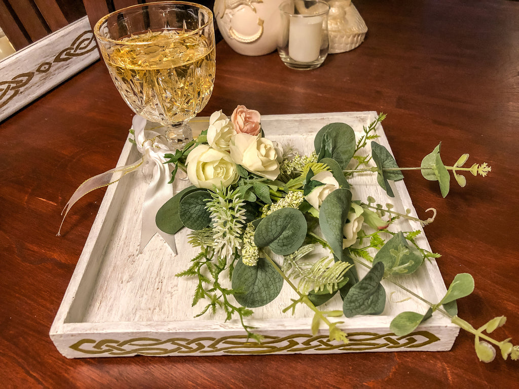 Wedding-inspired faux floral display with up-cycled champagne glass in a tray
