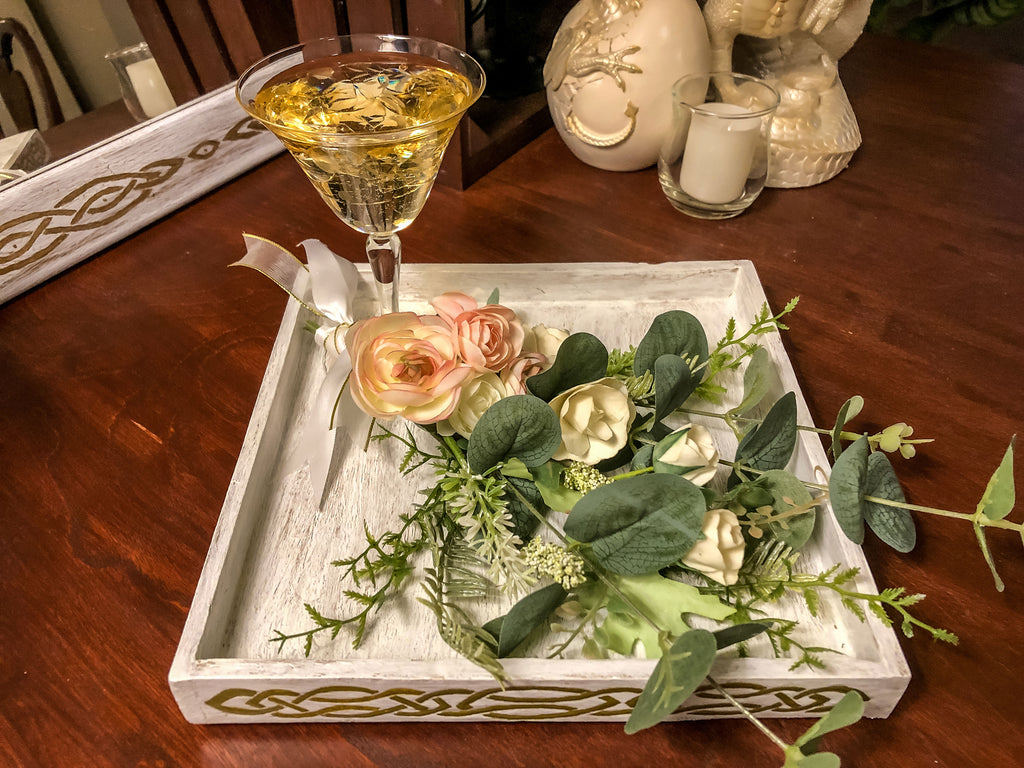 Wedding-inspired faux floral display with up-cycled champagne glass in a tray
