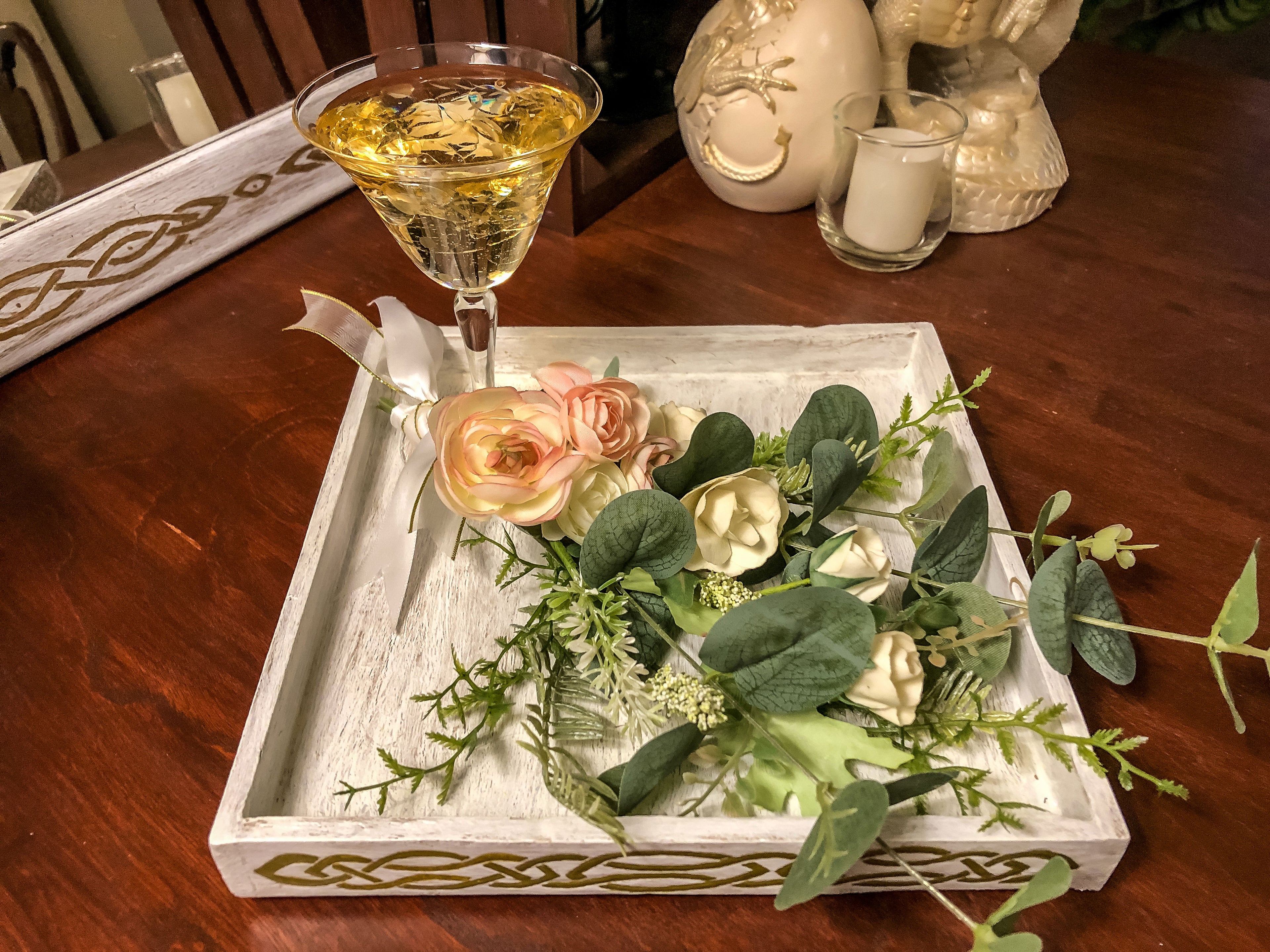 Wedding-inspired faux floral display with up-cycled champagne glass in a tray