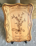 Small wood plaque with an orchid and the word beauty on a stand