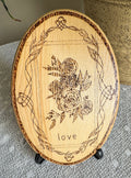 Small wood plaque with roses and the word love on a stand