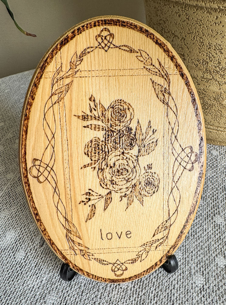 Small wood plaque with roses and the word love on a stand
